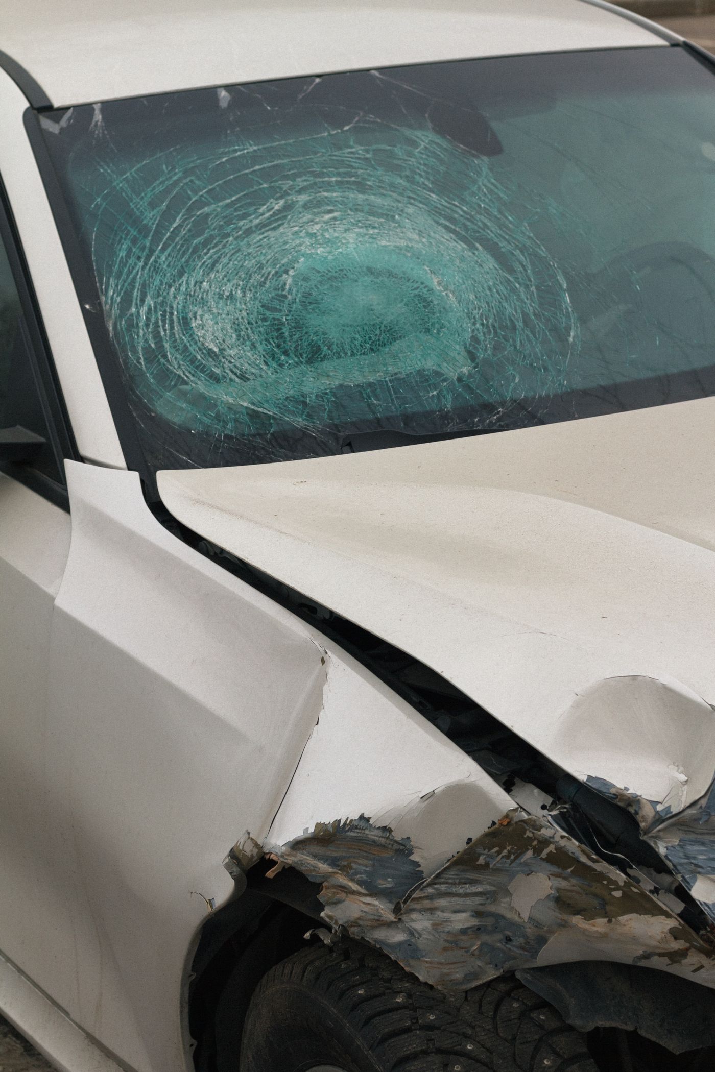 Car with a shattered windshield and front-end damage